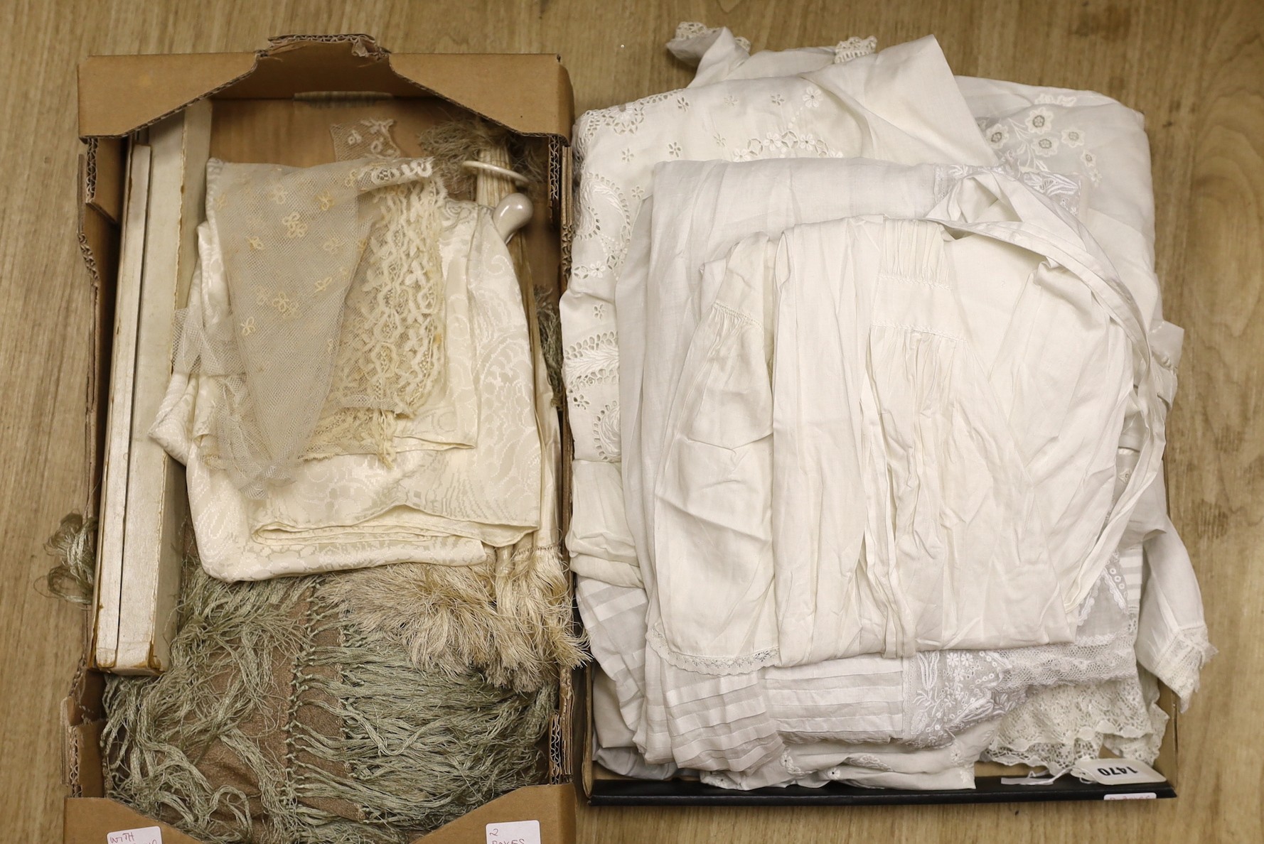 A collection of white worked christening gowns, a christening cape, a silk parasol, a lace bonnet veil and later shawl.